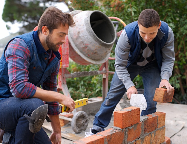 men-tools-bricks-outdoor-with-cement-construction-building-masonry-job-skill-young-people-bricklayer-artisan-talking-with-equipment-builder-worker-wall_590464-327756.jpg